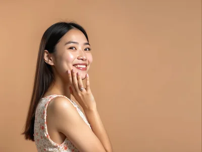 Smiling Young Asian Woman Touching Her Face