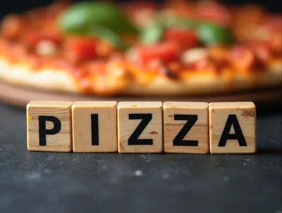Wooden Blocks Spelling Pizza With Blurred Pizza Background