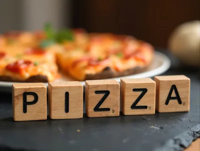 Wooden Letter Blocks Spelling Pizza With Blurred Pizza Background