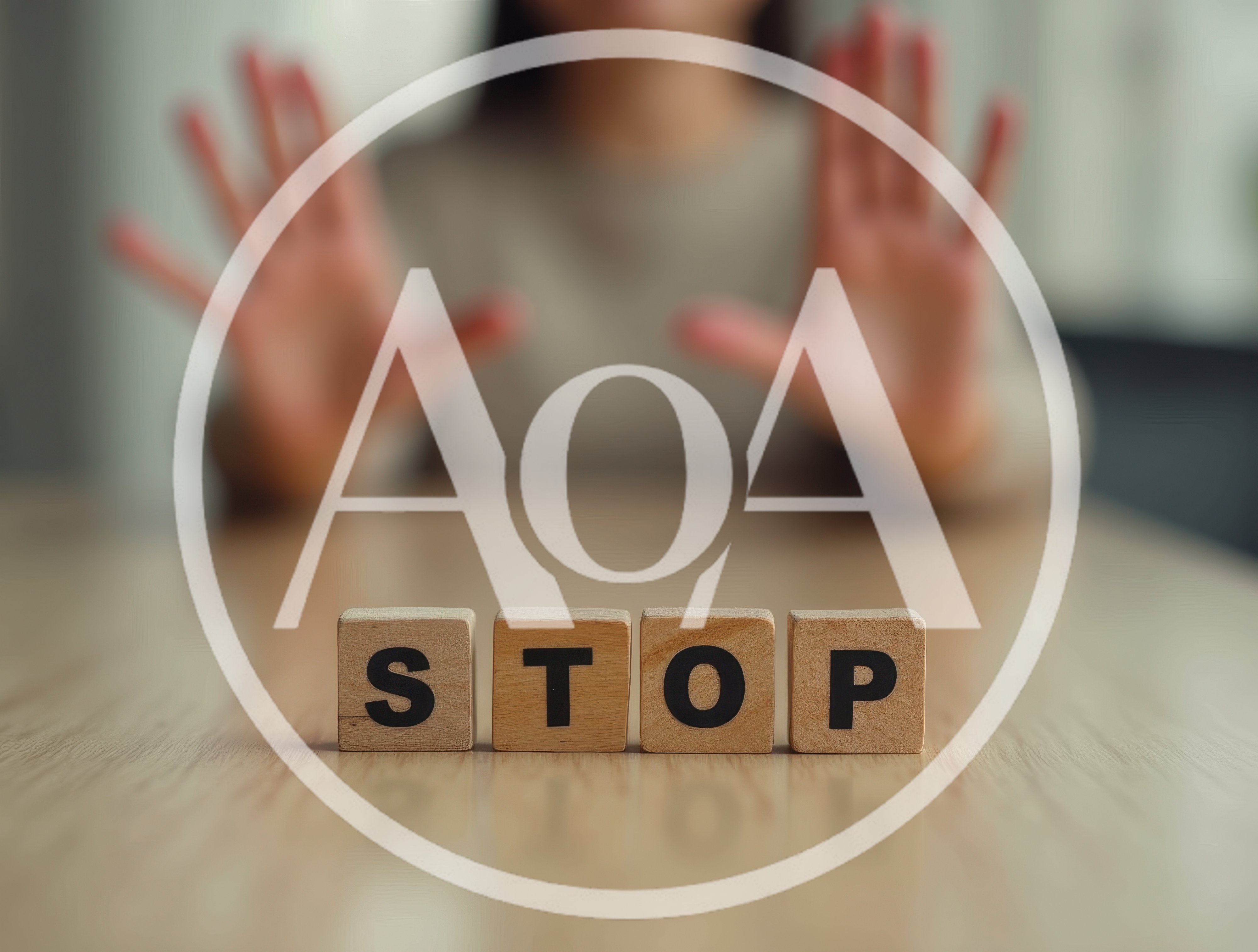 Person Making Stop Gesture Behind Wooden Blocks