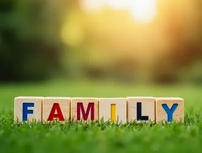 Wooden Alphabet Blocks Spelling Family On Green Grass