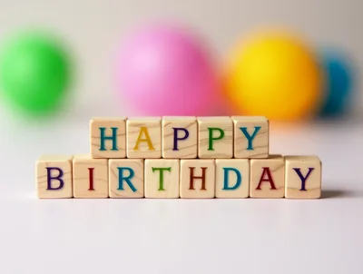 Wooden Blocks Spelling Happy Birthday With Colorful Balloons