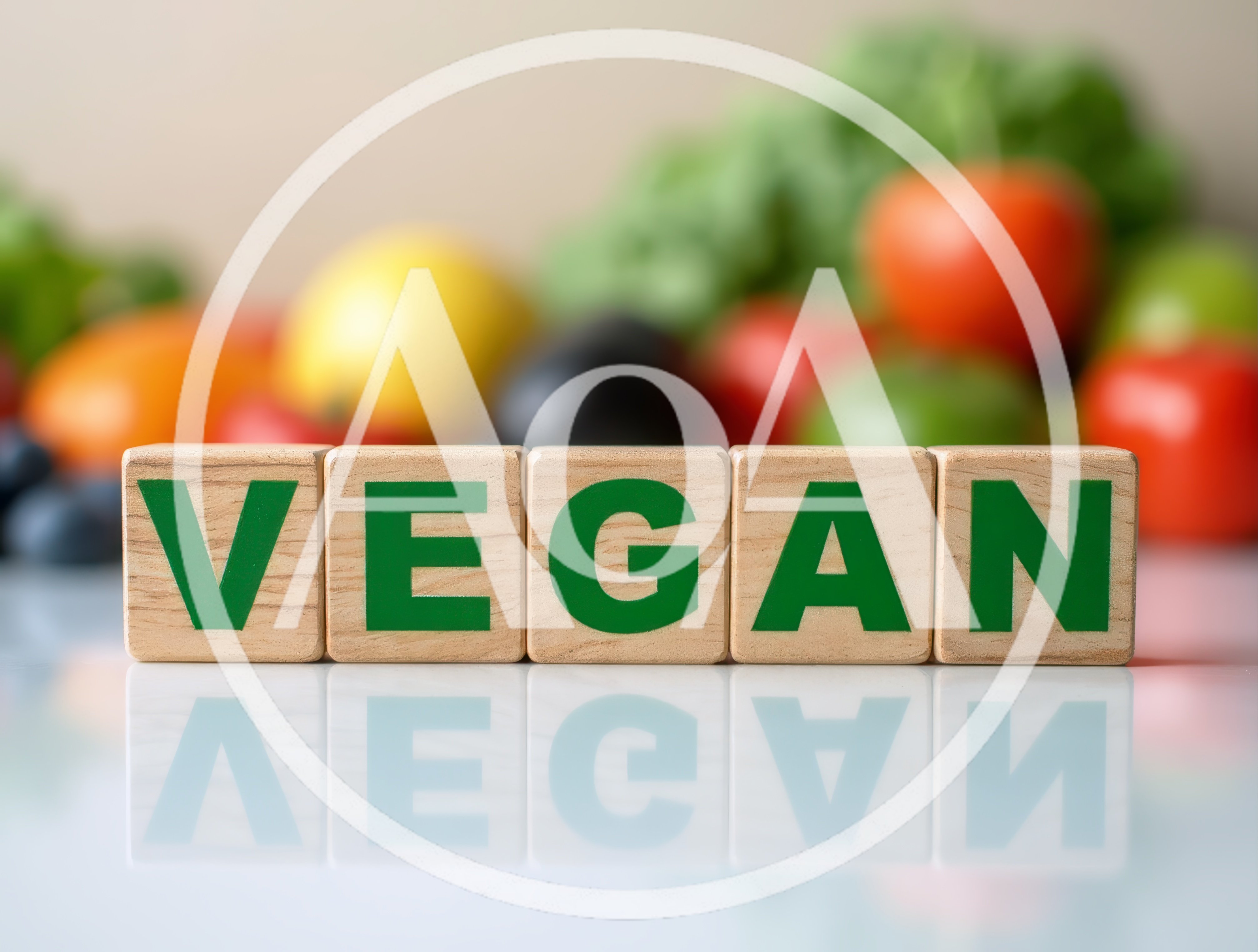 Wooden Blocks Spelling Vegan With Fresh Vegetables Background