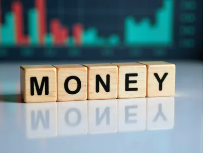 Wooden Blocks Spelling Money With Financial Chart Background