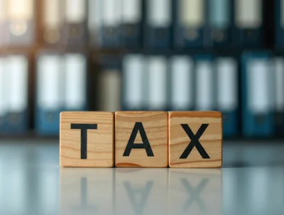 Wooden Blocks Spelling Tax In Front Of Office Binders