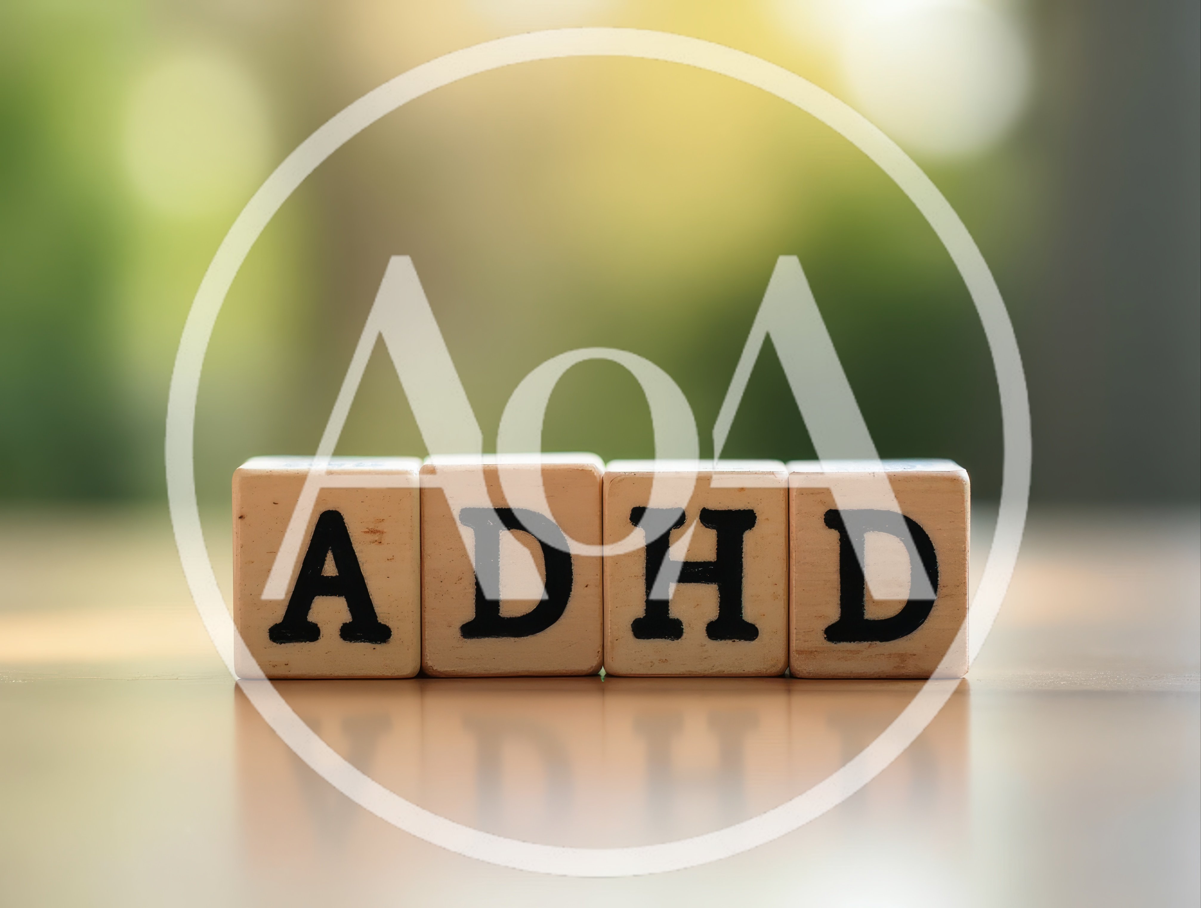 Wooden Blocks Spelling ADHD On A Reflective Surface