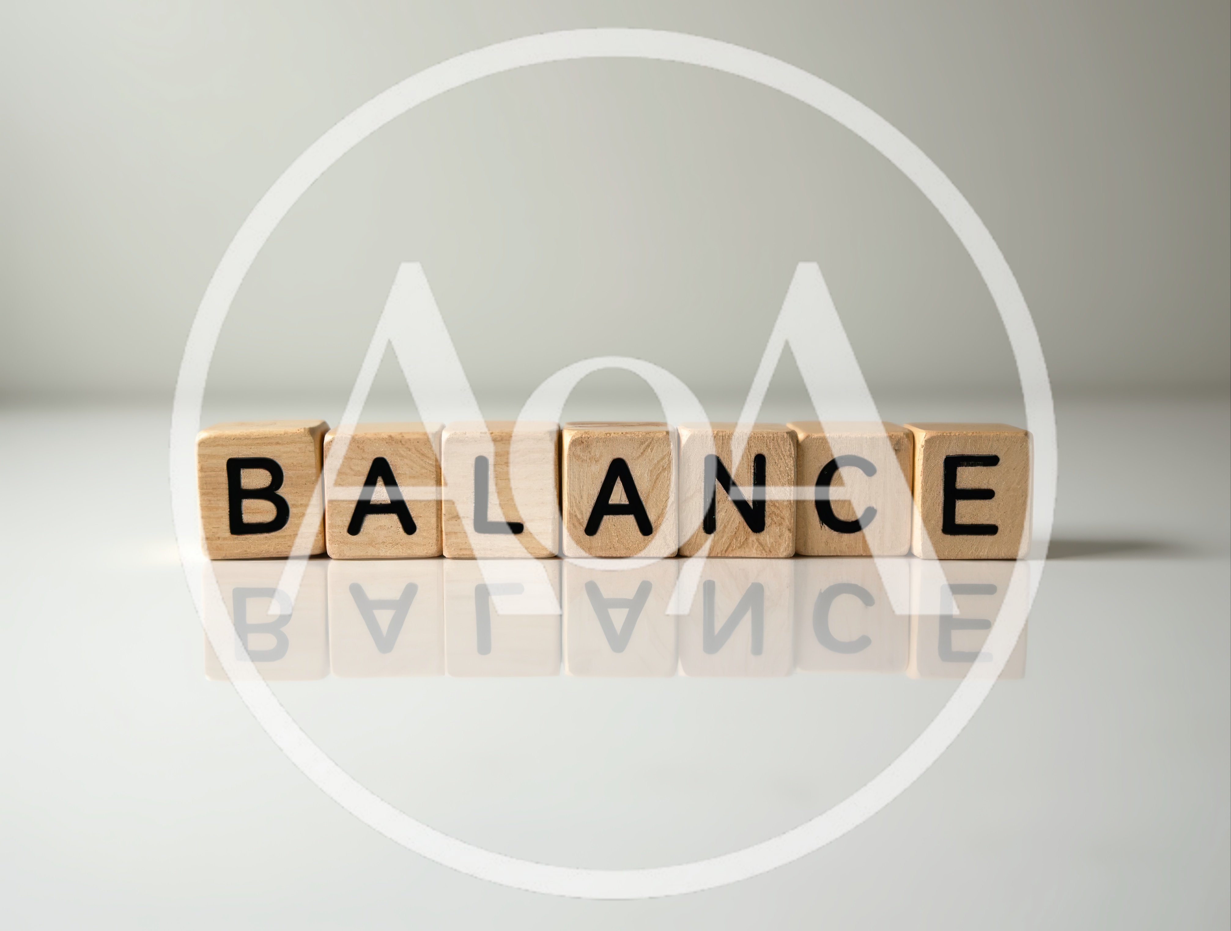 Wooden Blocks Spelling Balance on Reflective Surface