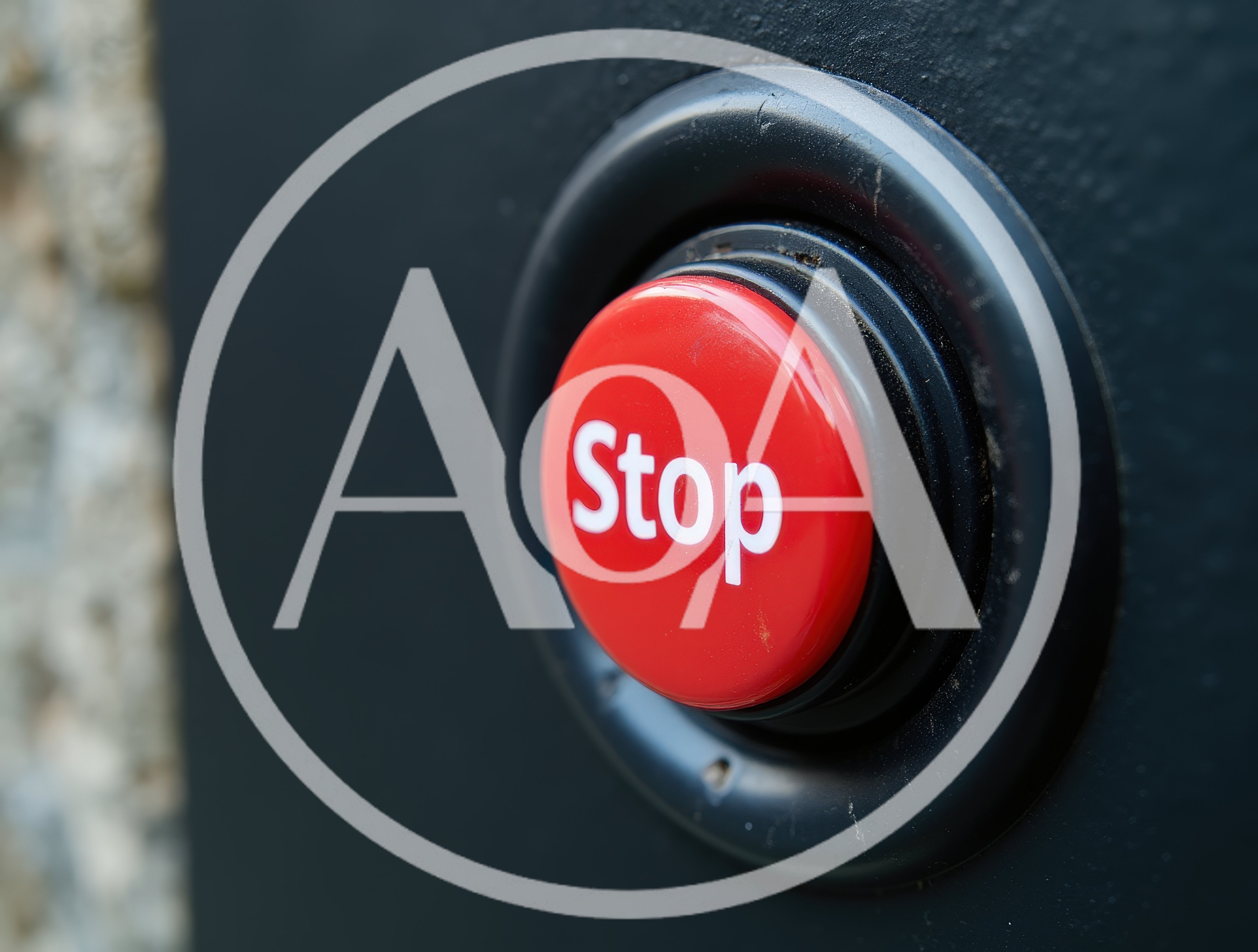 Red Stop Button Mounted On A Dark Wall