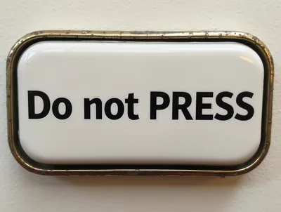 Do Not Press Sign On A Wall