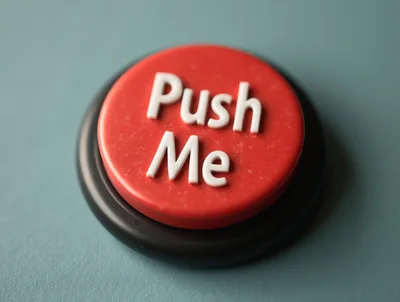 Red Push Me Button On A Teal Surface