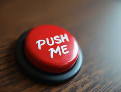 Red Push Me Button On Wooden Surface