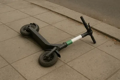 Electric Scooter Lying On A City Sidewalk