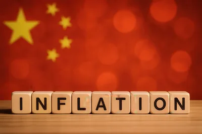 Wooden Blocks Spelling Inflation Against Chinese Flag Background