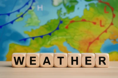 Wooden Blocks Spelling Weather In Front Of Map