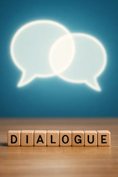 Wooden Blocks Spelling Dialogue With Glowing Speech Bubbles