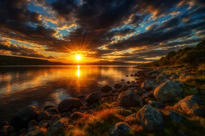 Golden Sunset Over A Rocky Lake Shoreline