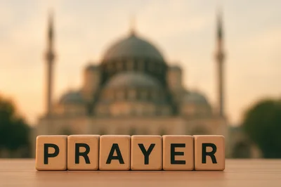 Wooden Blocks Spelling Prayer In Front Of A Mosque
