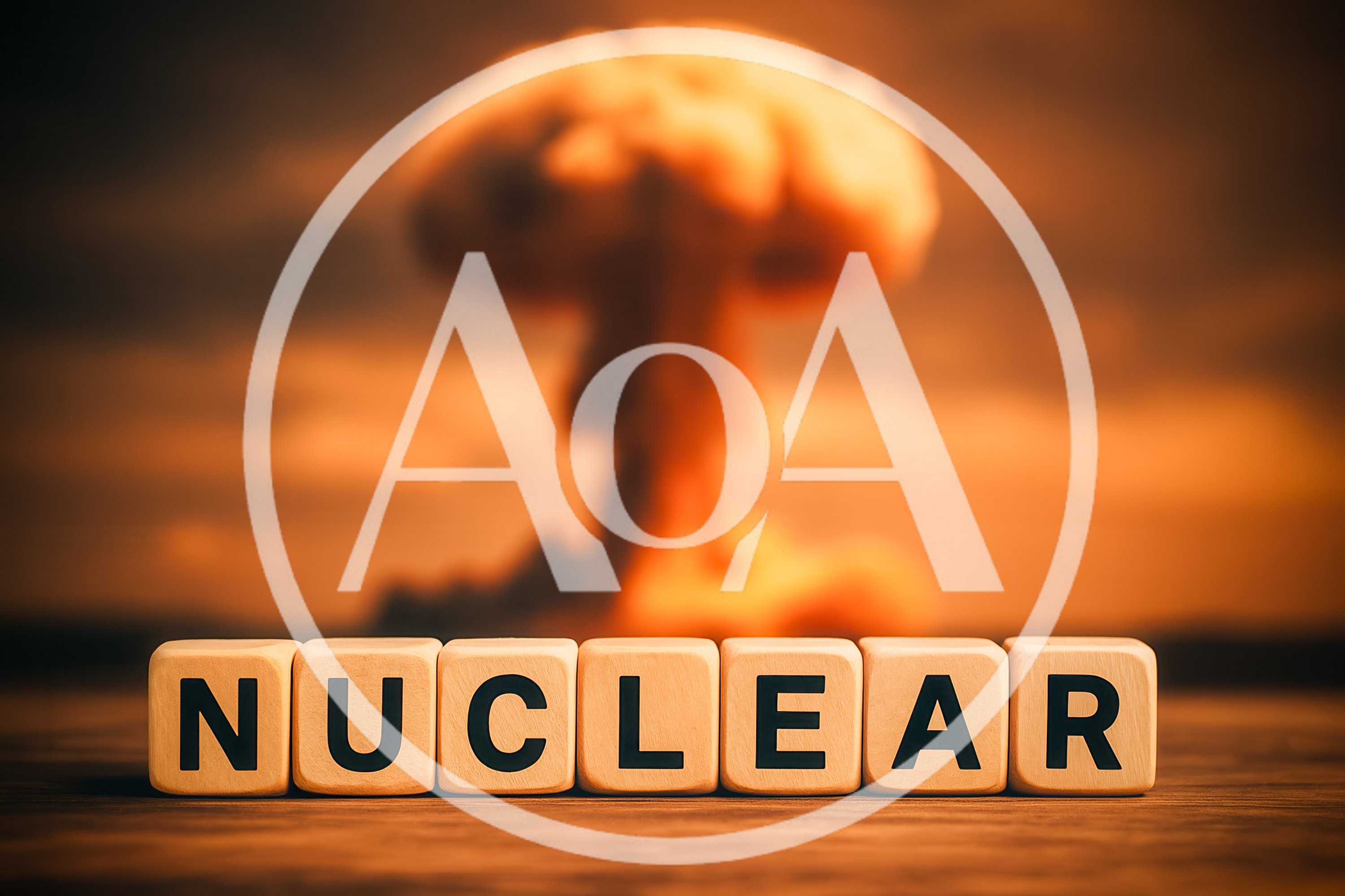 Wooden Blocks Spelling Nuclear Before A Mushroom Cloud