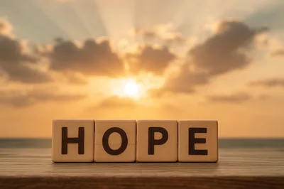 Wooden Blocks Spelling Hope Against A Sunset Background