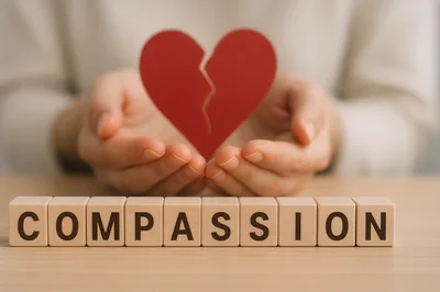 Hands Holding A Broken Heart Symbol With Compassion Blocks