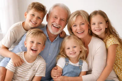 Happy Grandparents With Four Grandchildren Smiling Together