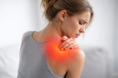 Young Woman Suffering From Severe Shoulder Pain