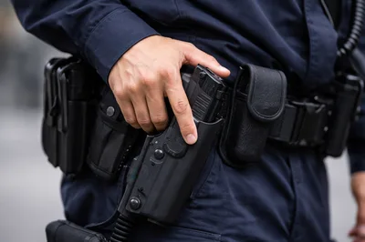 Police Officer Hand Resting On Duty Holster