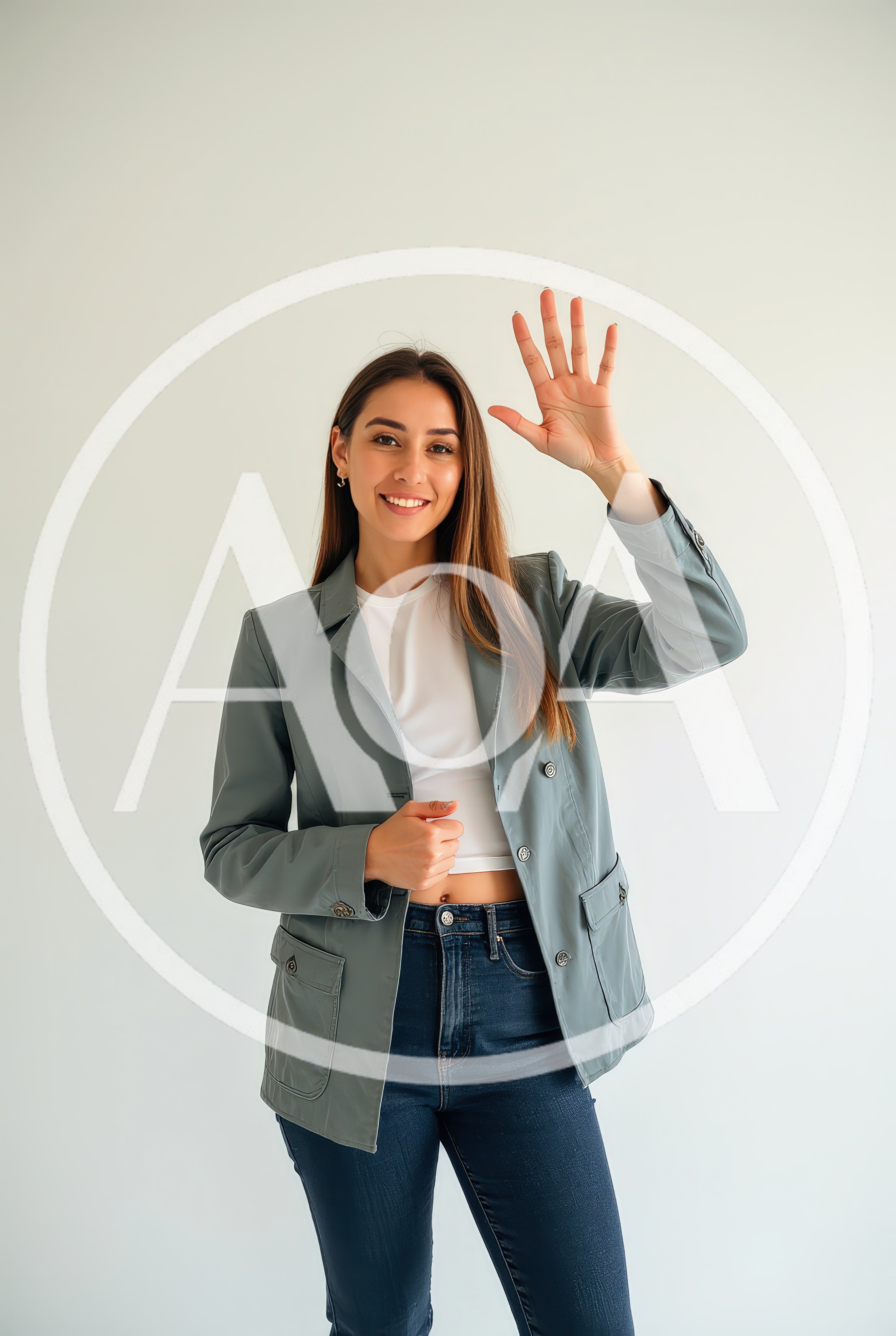 Young Woman Waving Hello Against A Plain Background