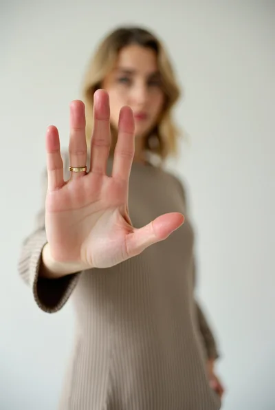 Woman Holding Up Hand In Stop Gesture