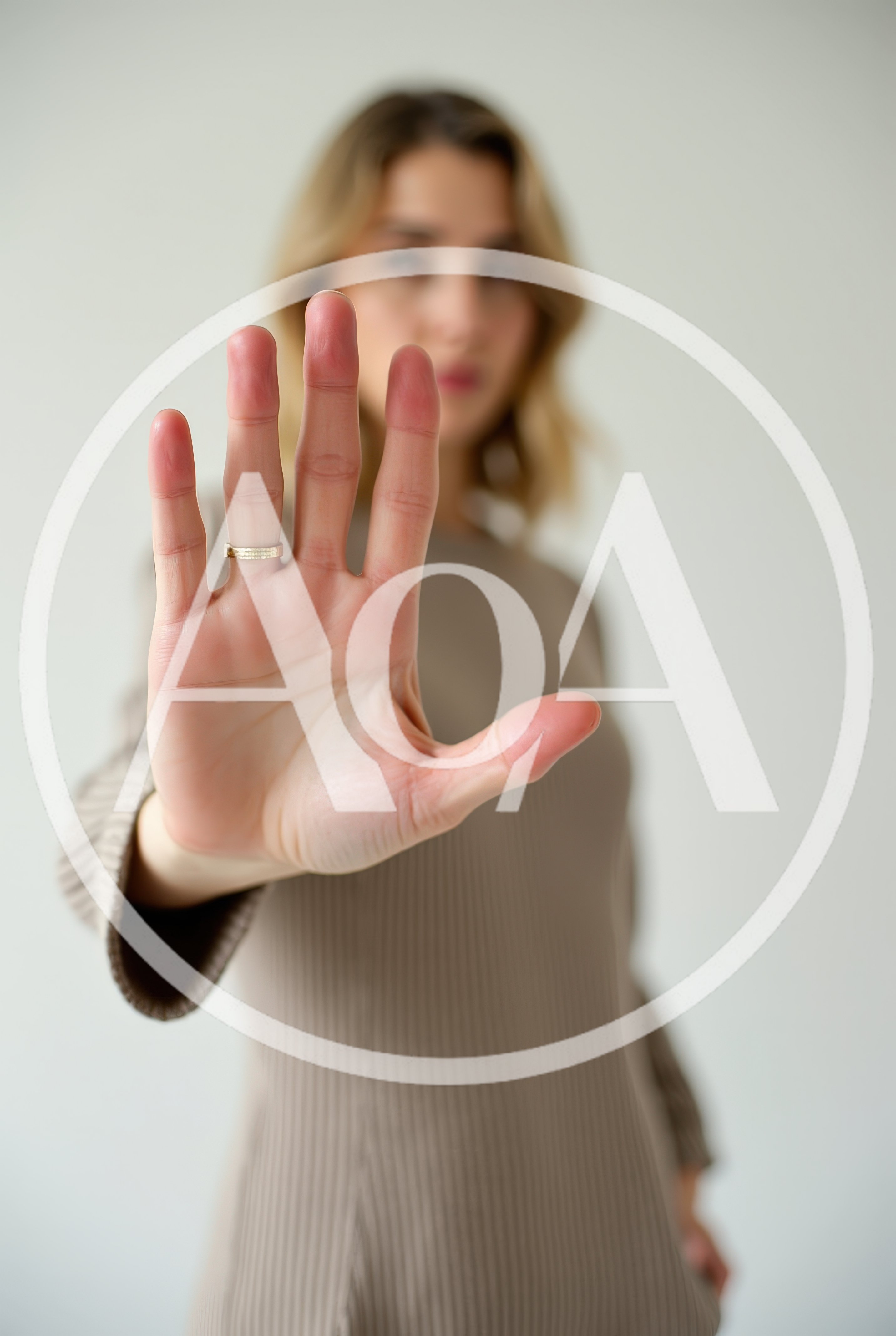 Woman Holding Up Hand In Stop Gesture
