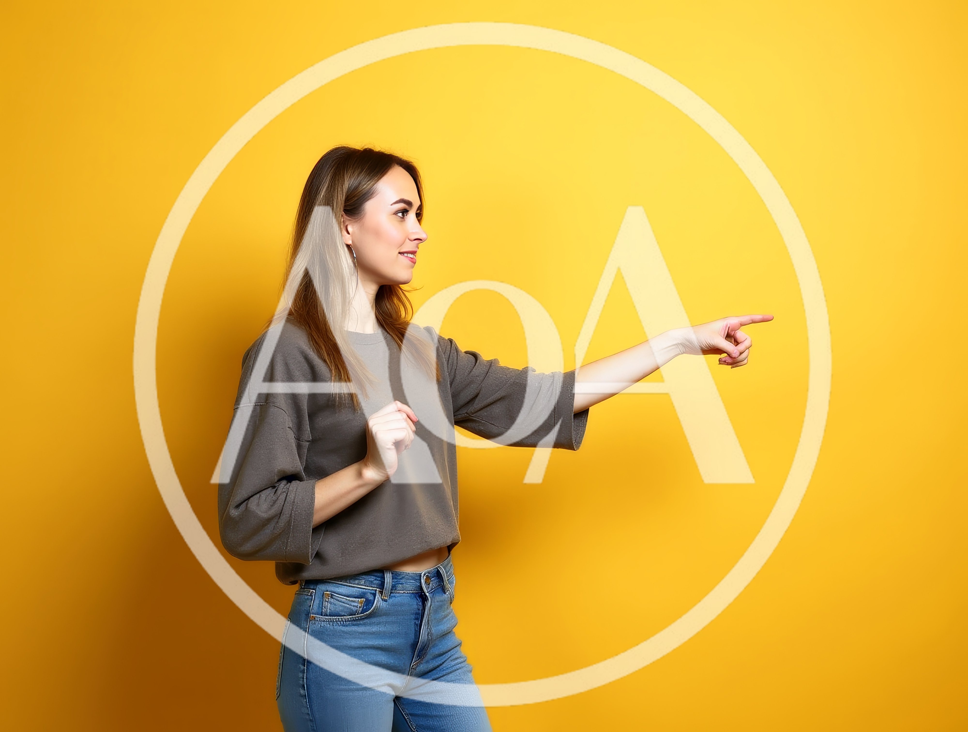 Young Woman Pointing To The Side Against Yellow Background