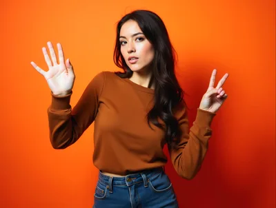 Young Woman Gesturing With Hands Against Orange Background