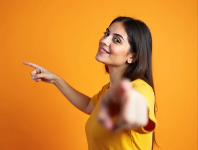 Young Woman Pointing At Camera And To The Side