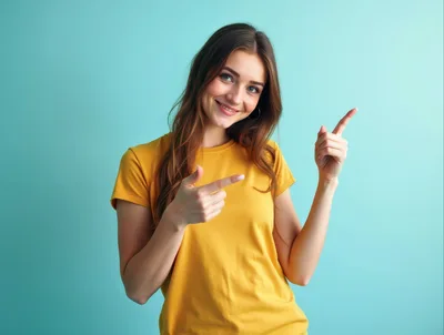 Young Woman Pointing Upwards Against A Teal Background