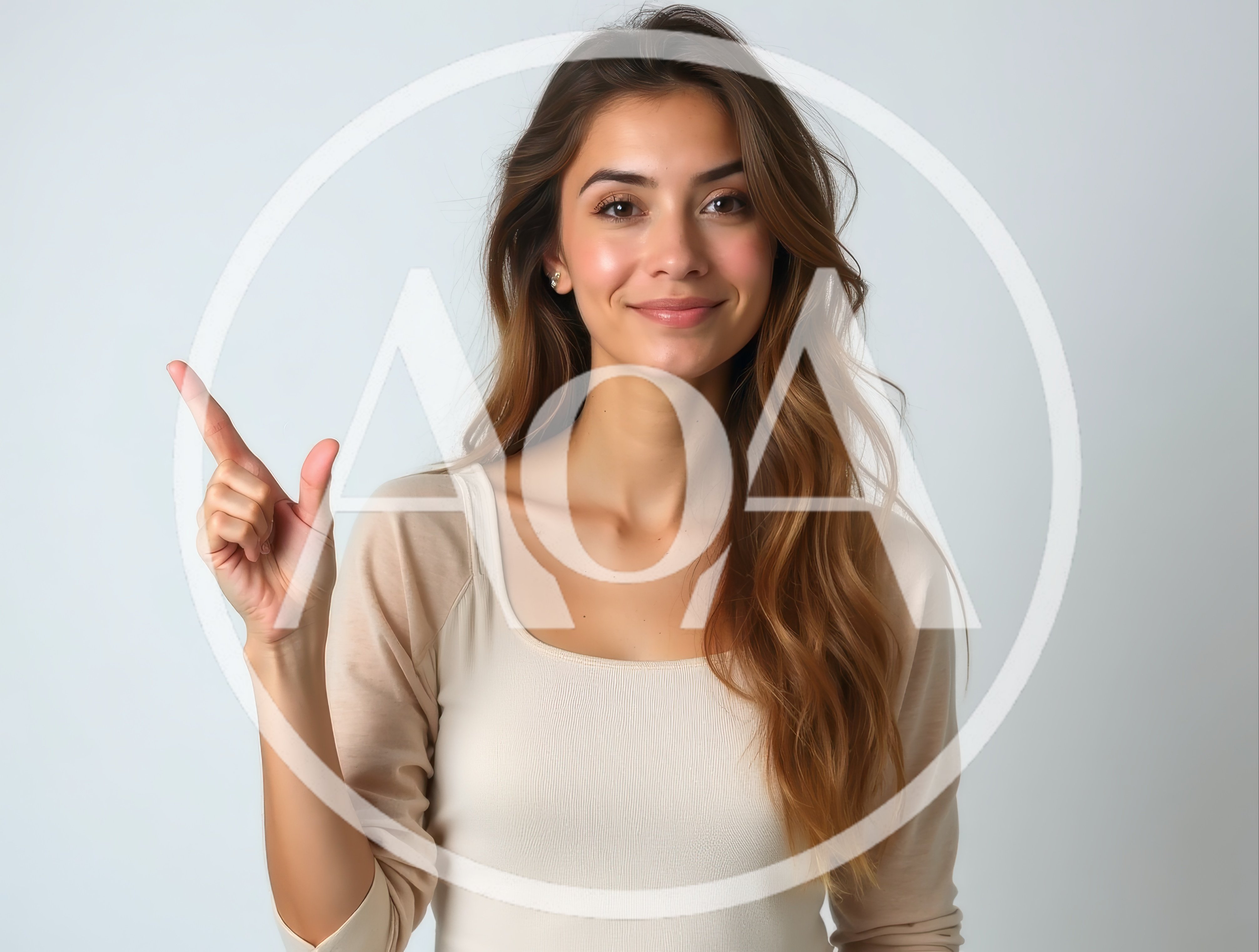 Young Woman Pointing Upwards Against A Plain Background