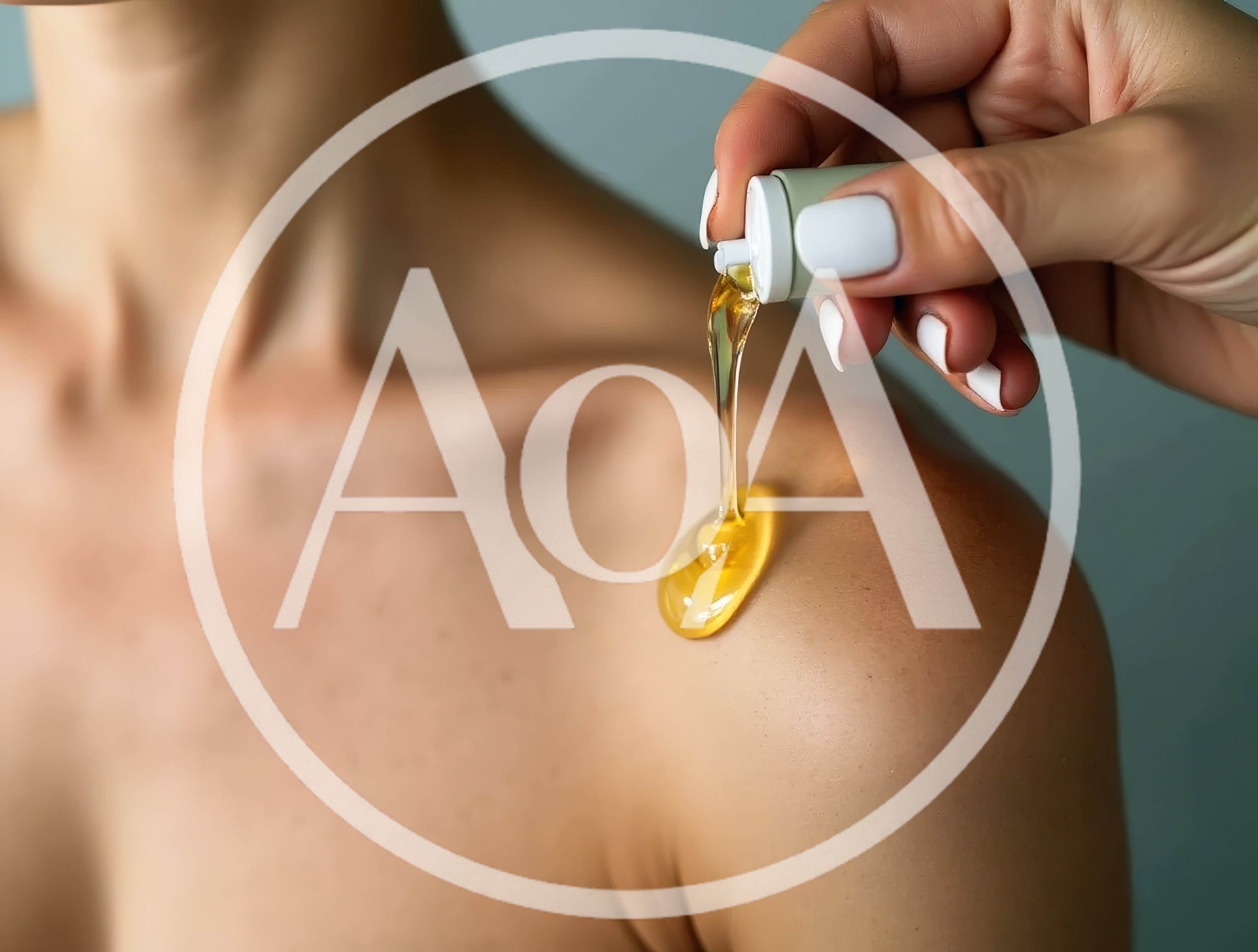 Applying Golden Massage Oil To A Woman's Shoulder