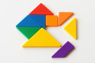 Colorful Tangram Puzzle Pieces Arranged On White Background