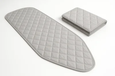 Grey Quilted Ironing Board Cover and Folded Fabric