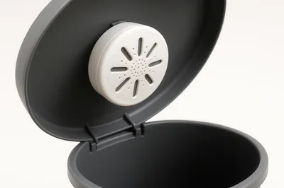 Deodorizer Pod Attached Inside A Gray Trash Can Lid