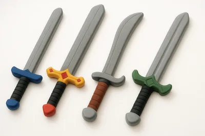 Four Toy Foam Swords Arranged On White Background