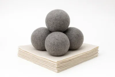 Grey Wool Dryer Balls On Stacked Felt Sheets
