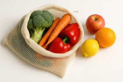 Fresh Vegetables And Fruits In A Reusable Mesh Bag