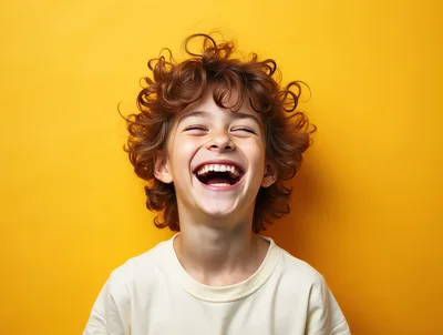 Joyful Young Boy With Curly Hair Laughing