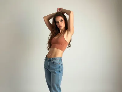 Young Woman Posing In Crop Top And Jeans
