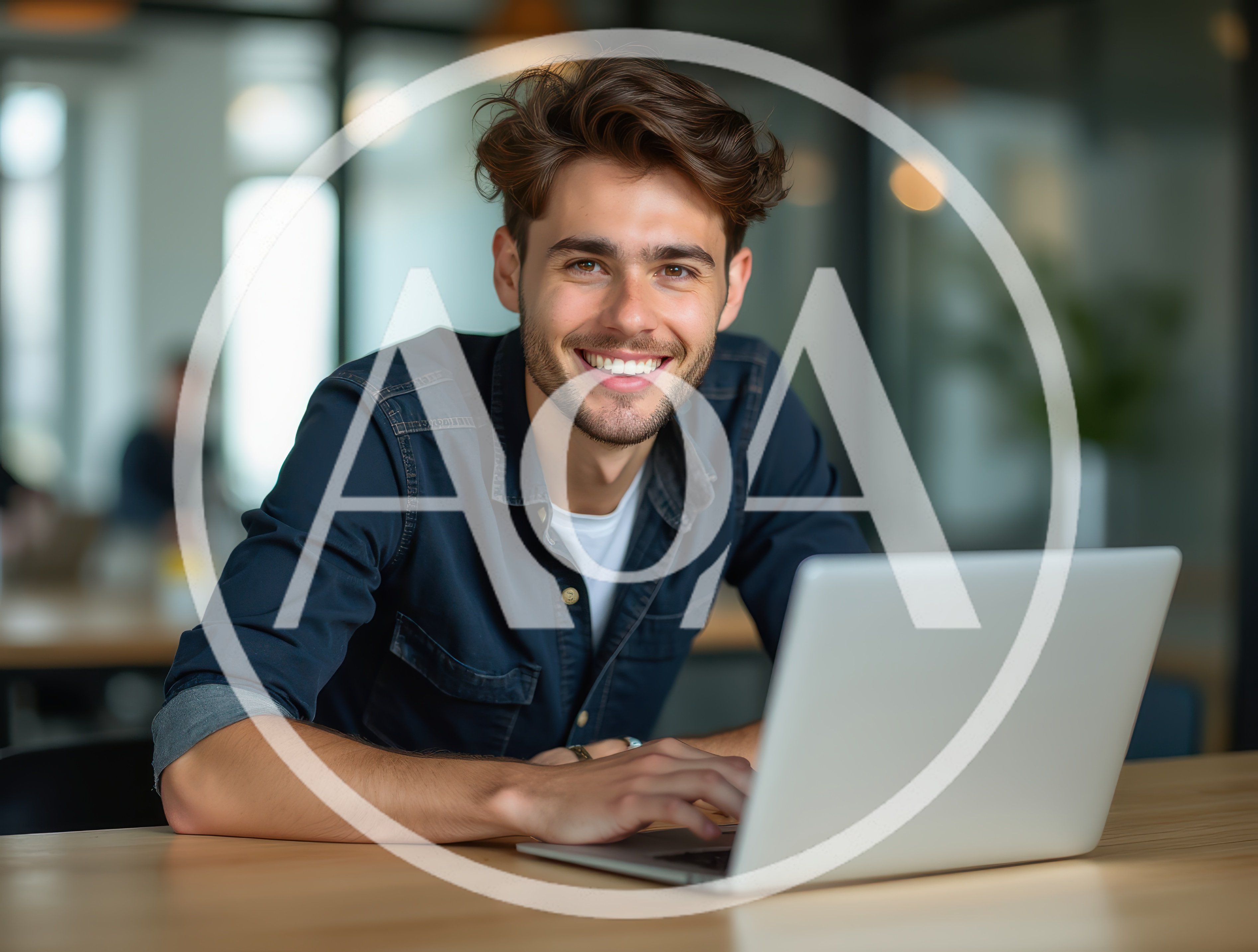 Young Man Working On Laptop In Modern Office