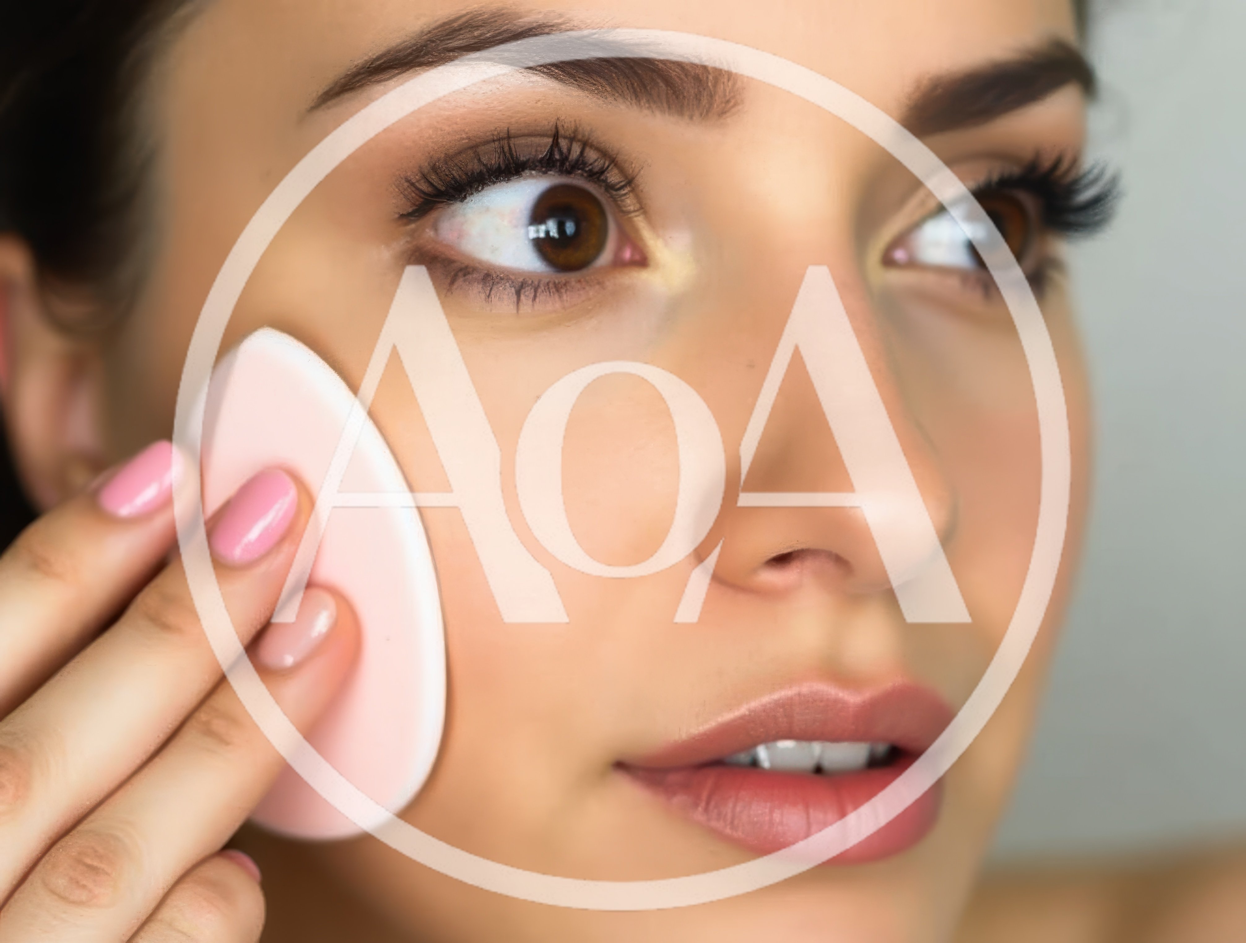 Young Woman Applying Foundation With Makeup Sponge