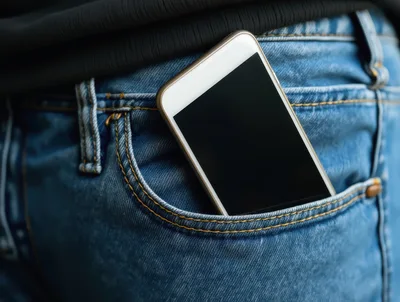 Smartphone Tucked Into Blue Denim Jeans Pocket