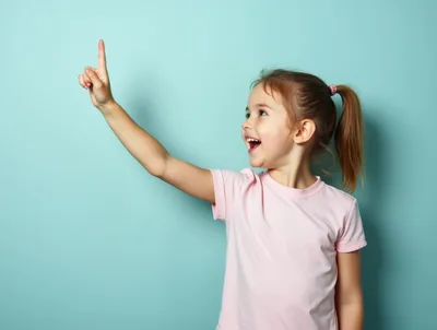 Happy Little Girl Pointing Upwards