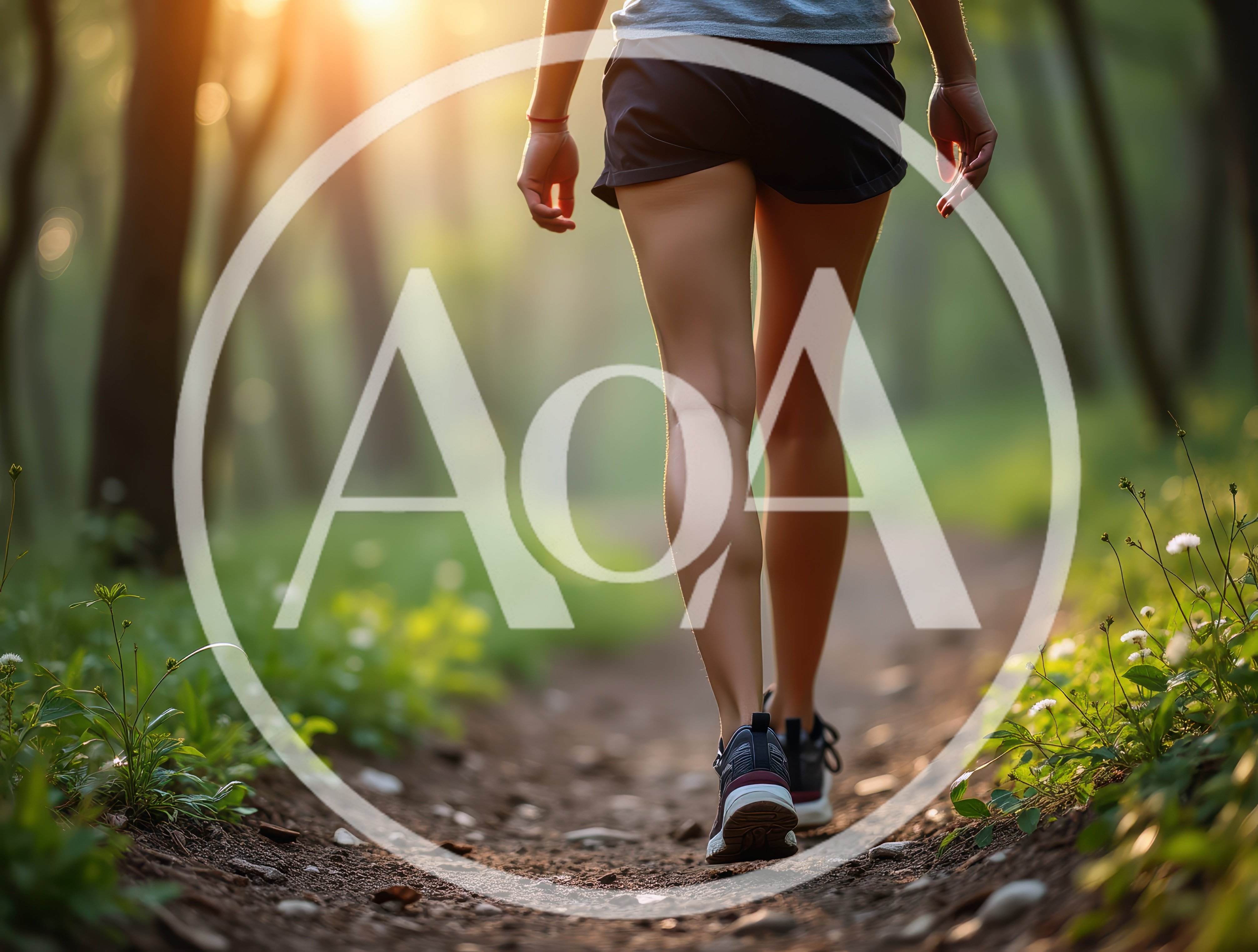 Woman Walking Along A Forest Trail At Sunset