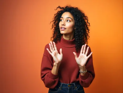 Young Woman With Curly Hair Gesturing With Open Hands